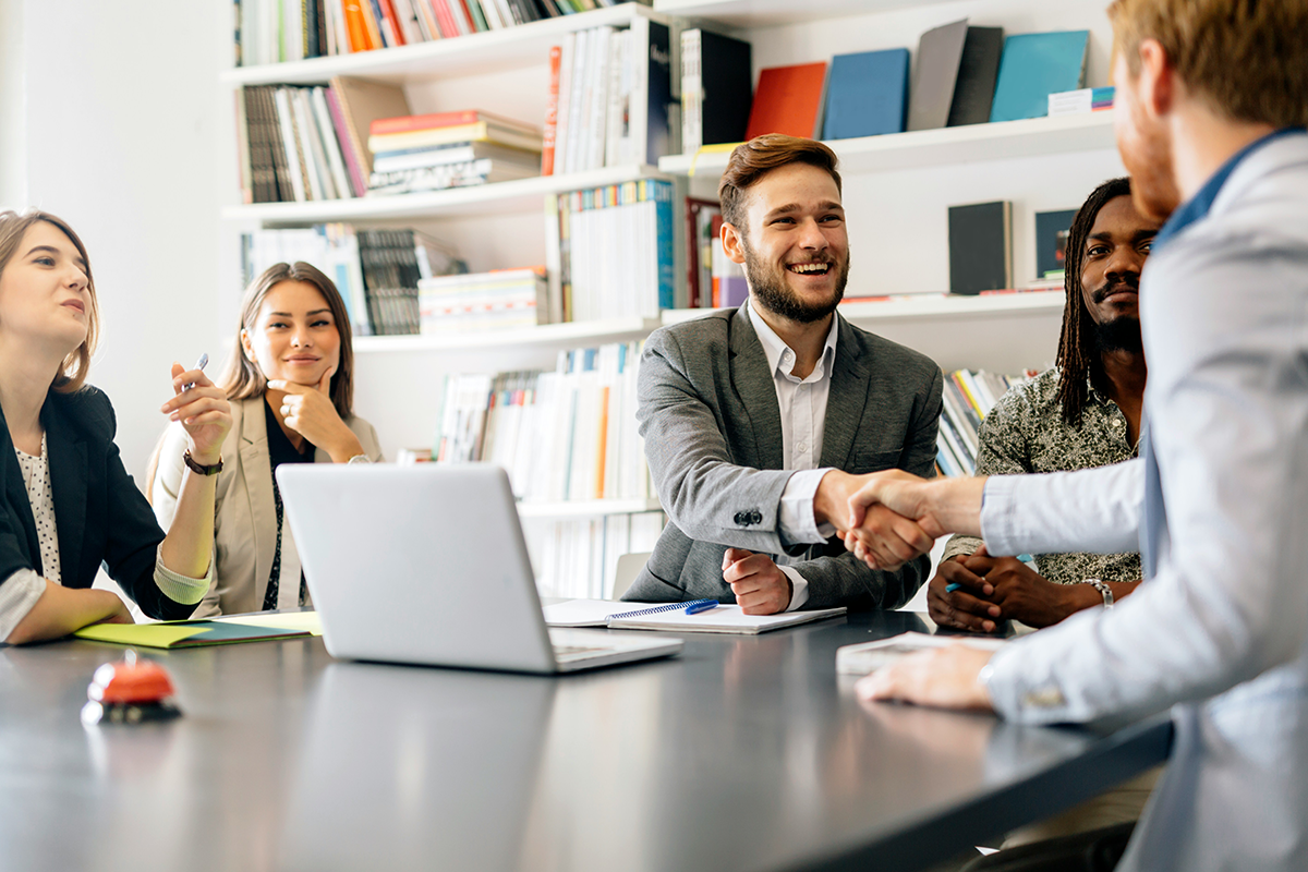 Colleagues shaking hands in a meeting